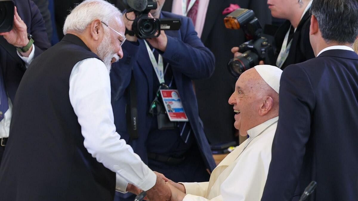 <div class="paragraphs"><p>Pope Francis greets Prime Minister Narendra Modi as he arrives for a session during the G7 Summit.</p></div>