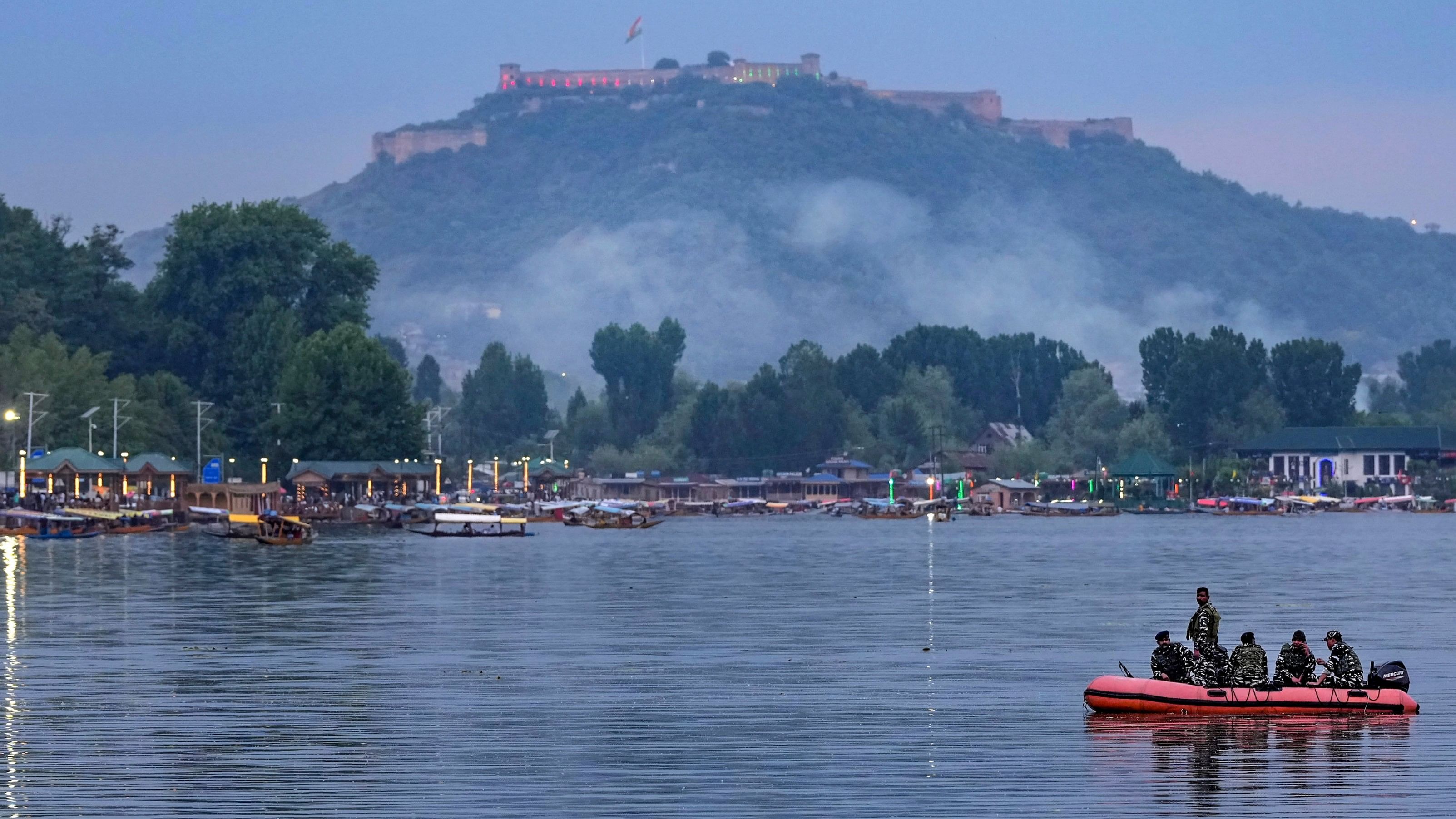 <div class="paragraphs"><p>Security personnel patrol on boat at the Dal Lake as house boats crowd the shore.</p></div>