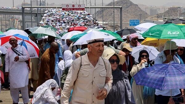 <div class="paragraphs"><p>Muslim pilgrims walk with umbrellas on the third day of the Satan stoning ritual, amid extremely hot weather, during the annual haj pilgrimage, in Mina, Saudi Arabia, June 18, 2024.</p></div>