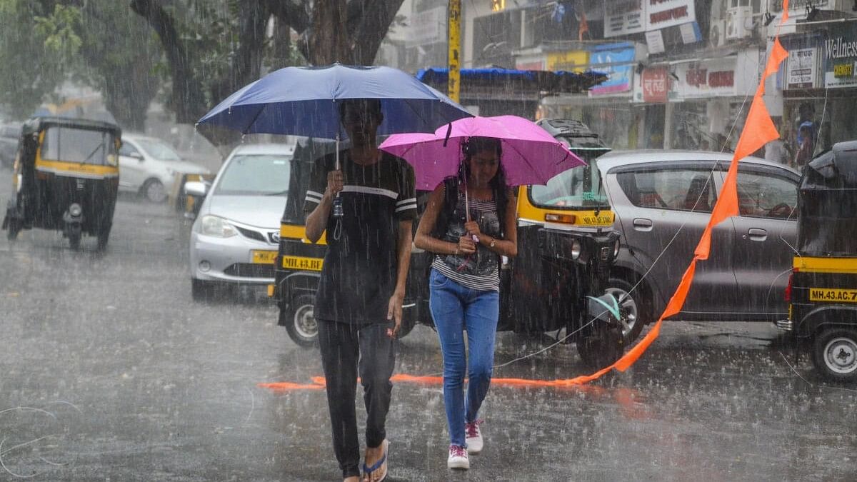 <div class="paragraphs"><p>Representative image showing two individuals walking a rainy street in Mumbai.</p></div>