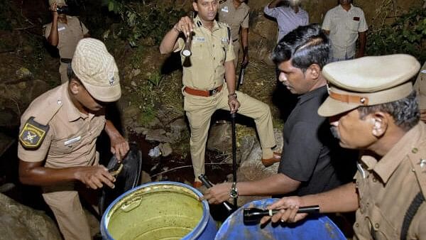 <div class="paragraphs"><p>Trichy Collector Pradeep Kumar and Superintendent of Police Arun Kumar destroy 250 liters of illegally brewed liquor, in Nesakulam area near Pacchimalai in Tiruchirappalli district, Friday, June 21, 2024.</p></div>