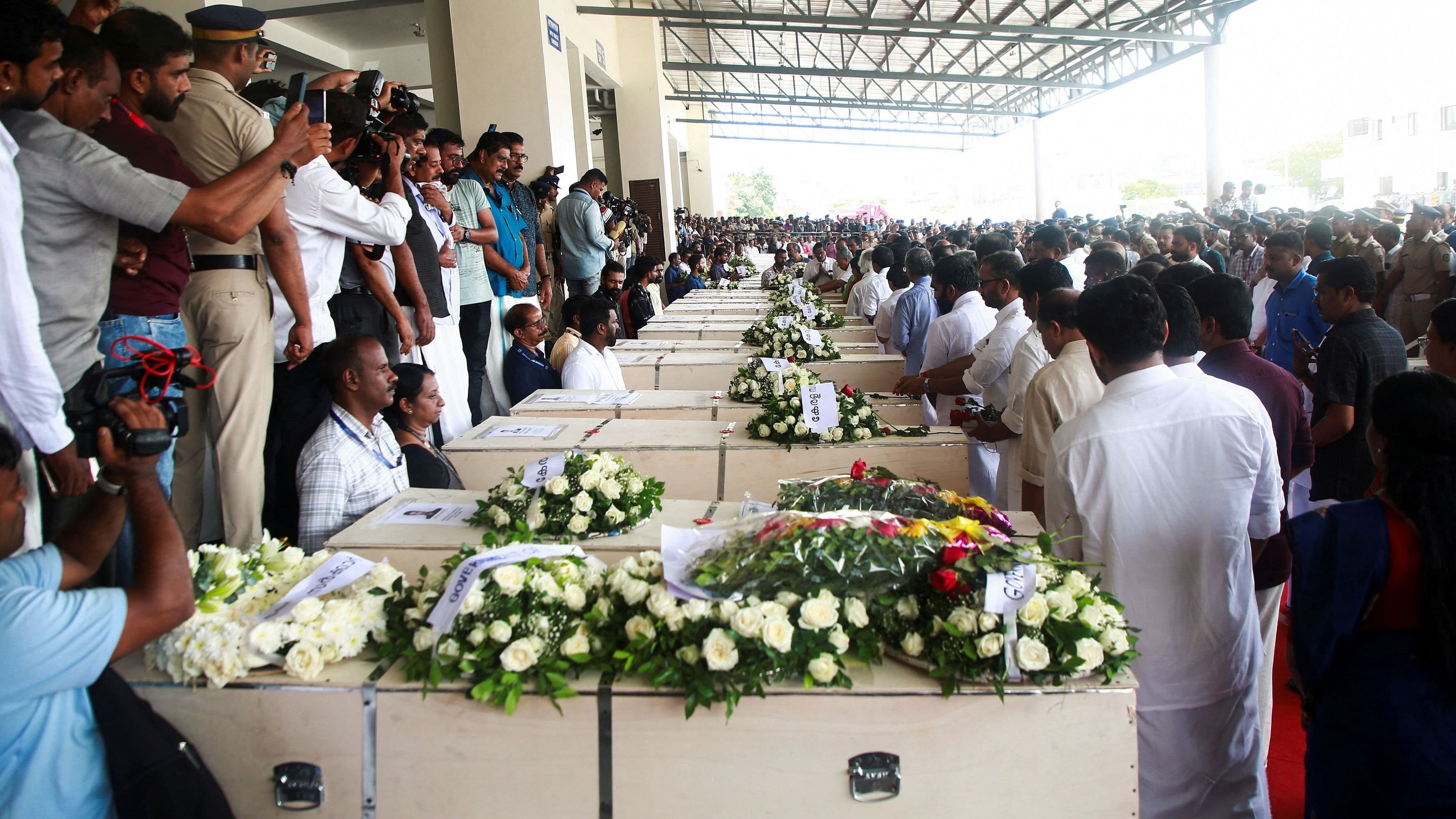 <div class="paragraphs"><p>People gather around the coffins containing the bodies of people who died during a fire that broke out in a building housing foreign workers in Kuwait, upon their arrival at Cochin International Airport, in Kochi, in the southern Indian state of Kerala, on June 14, 2024. </p></div>