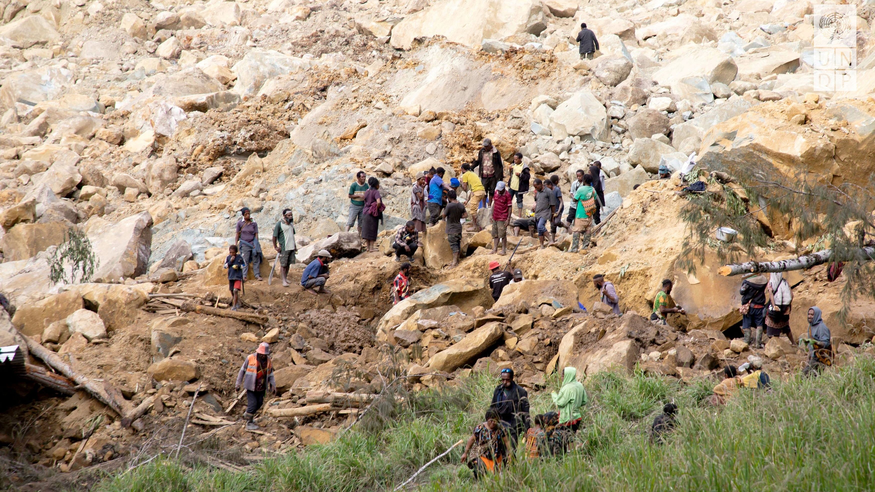 <div class="paragraphs"><p>People clear an area at the site of a landslide in Yambali village, Enga Province, Papua New Guinea, May 27, 2024.</p></div>