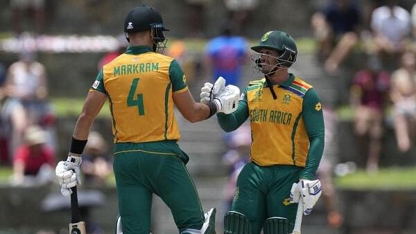 <div class="paragraphs"><p>(L to R) South Africa's captain Aiden Markram,  and Quinton de Kock celebrate the partnership of 100 runs during the ICC Men's T20 World Cup cricket match between the United States and South Africa at Sir Vivian Richards Stadium in North Sound, Antigua and Barbuda, Wednesday, June 19, 2024.</p></div>