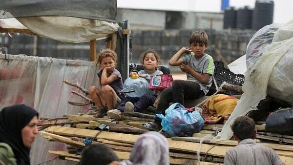 <div class="paragraphs"><p>Palestinians travel on foot along with their belongings as they flee Rafah due to an Israeli military operation.</p></div>