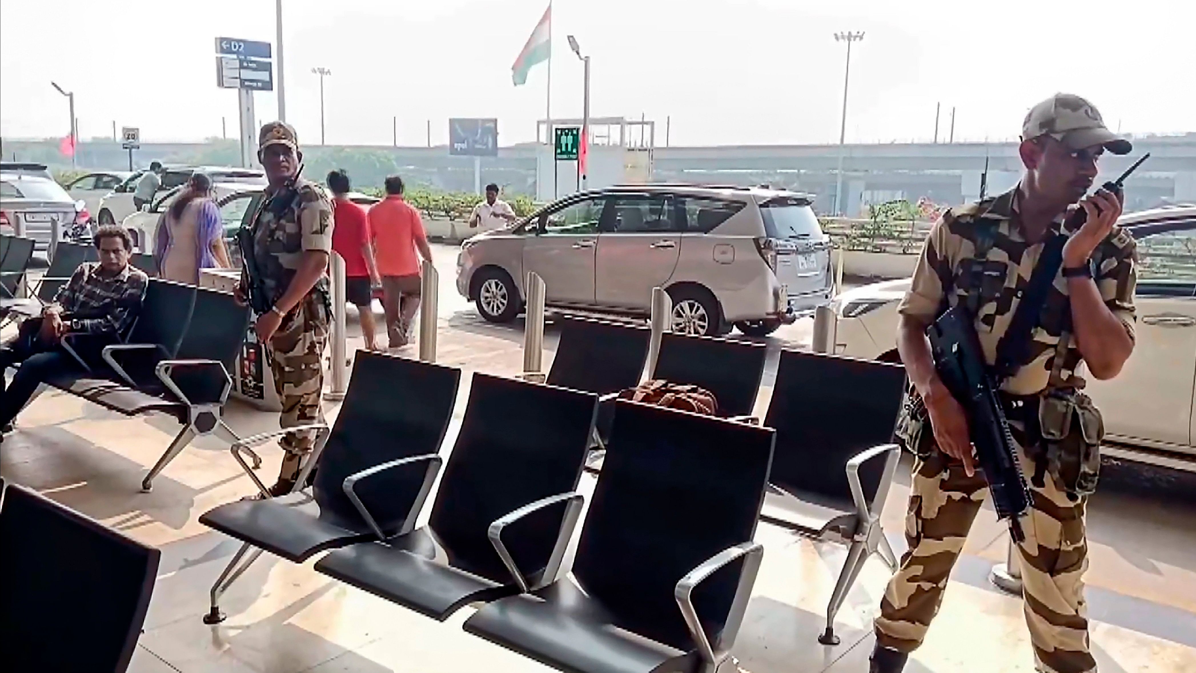 <div class="paragraphs"><p>Security personnel stand guard at the airport after a flight received bomb threat, in Chennai.</p></div>