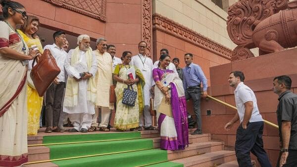 <div class="paragraphs"><p>Congress MP Rahul Gandhi arrives as TMC MPs look on at the Parliament House complex during the first session of the 18th Lok Sabha, in New Delhi.&nbsp;</p></div>