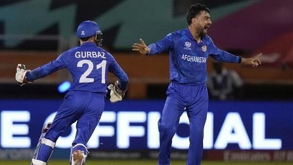 <div class="paragraphs"><p>Afghanistan's captain Rashid Khan celebrates after he bowled New Zealand's Mark Chapman during an ICC Men's T20 World Cup cricket match at Guyana National Stadium in Providence, Guyana.&nbsp;</p></div>