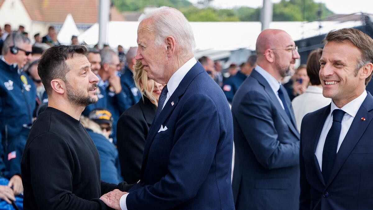 <div class="paragraphs"><p>US President Joe Biden talks with Ukraine's President Volodymyr Zelensky as France's President Emmanuel Macron looks on at the start of the International commemorative ceremony at Omaha Beach marking the 80th anniversary of the World War II "D-Day" Allied landings in Normandy, in Saint-Laurent-sur-Mer, in northwestern France.</p></div>