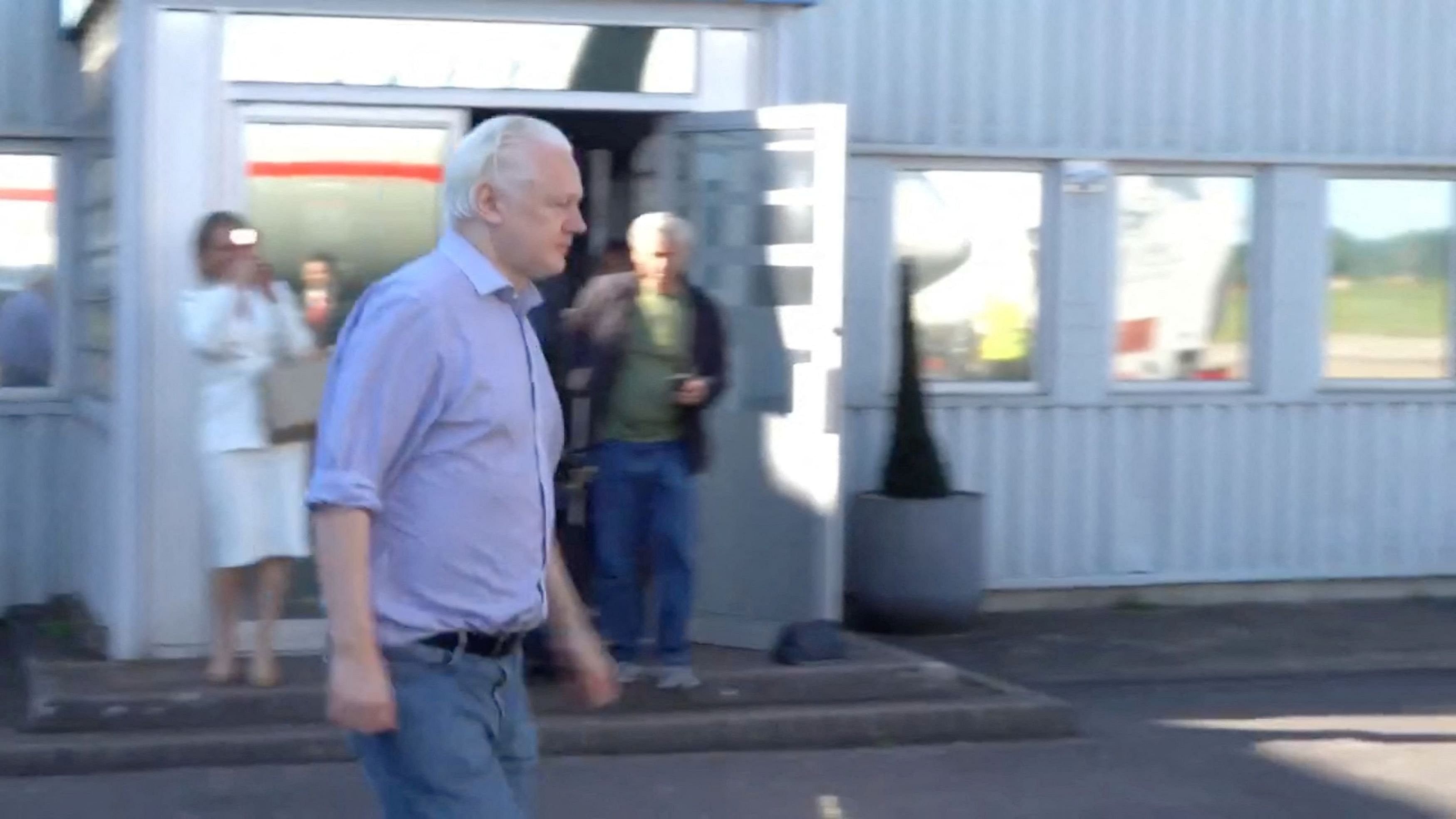 <div class="paragraphs"><p>WikiLeaks founder Julian Assange walks to board a plane at a location given as London, Britain, in this still image from video released JUNE 25, 2024.  </p></div>