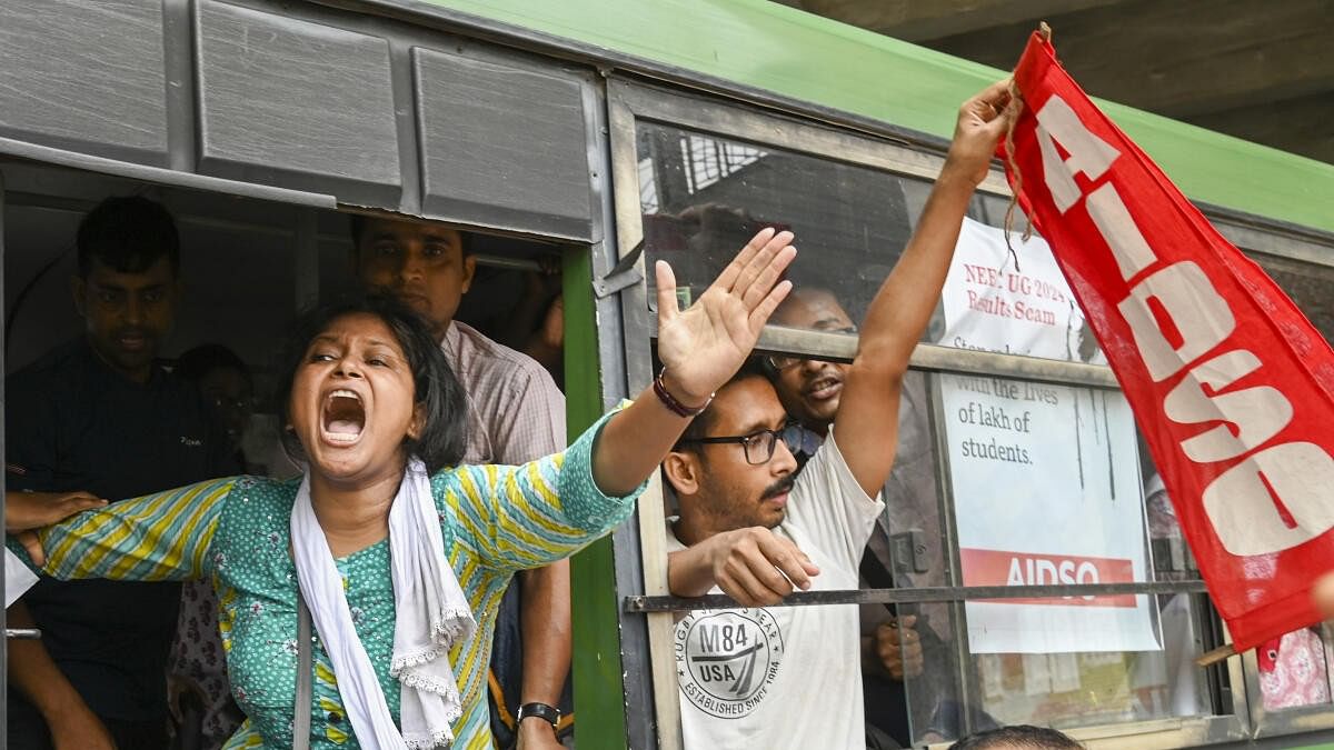 <div class="paragraphs"><p>Detained members of AIDSO (All India Democratic Students' Organisation) shout slogans during their protest against the alleged irregularities in NEET-UG entrance exam result-2024, at Salt Lake area in Kolkata, Thursday, June 13, 2024.</p></div>