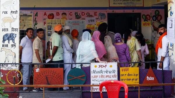 <div class="paragraphs"><p>Voters stand in line to cast their votes at a polling station during the seventh and last phase of the general election, in Firozpur district, Punjab.</p></div>