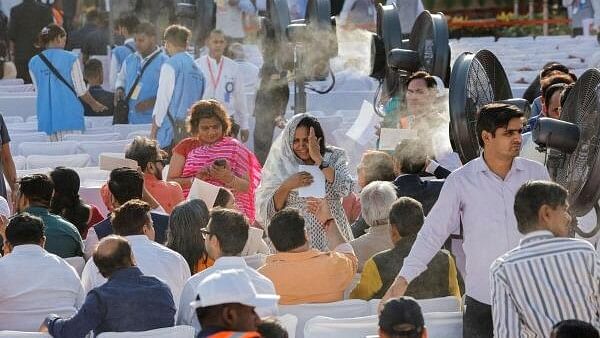 <div class="paragraphs"><p>People stand near fans, on the day of India's Prime Minister Narendra Modi's swearing-in ceremony at the presidential palace in New Delhi, India, June 9, 2024.</p></div>