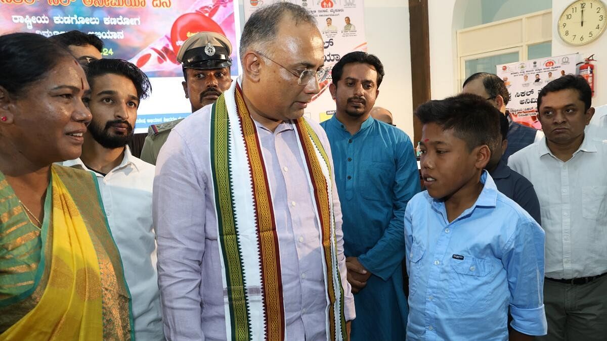 <div class="paragraphs"><p>Minister for Health and Family Welfare Dinesh Gundu Rao interacts with a 22-year-old sickle cell anaemia patient in Mysuru on Wednesday. </p></div>