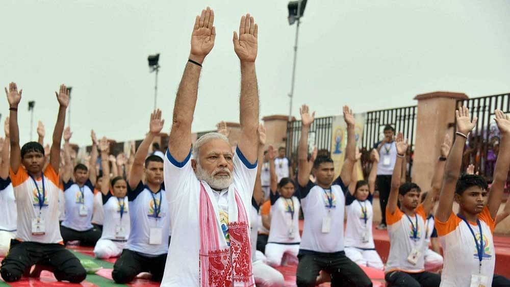 <div class="paragraphs"><p>Prime Minister Narendra Modi performs yoga along with thousands of others during a mass yoga event.</p></div>