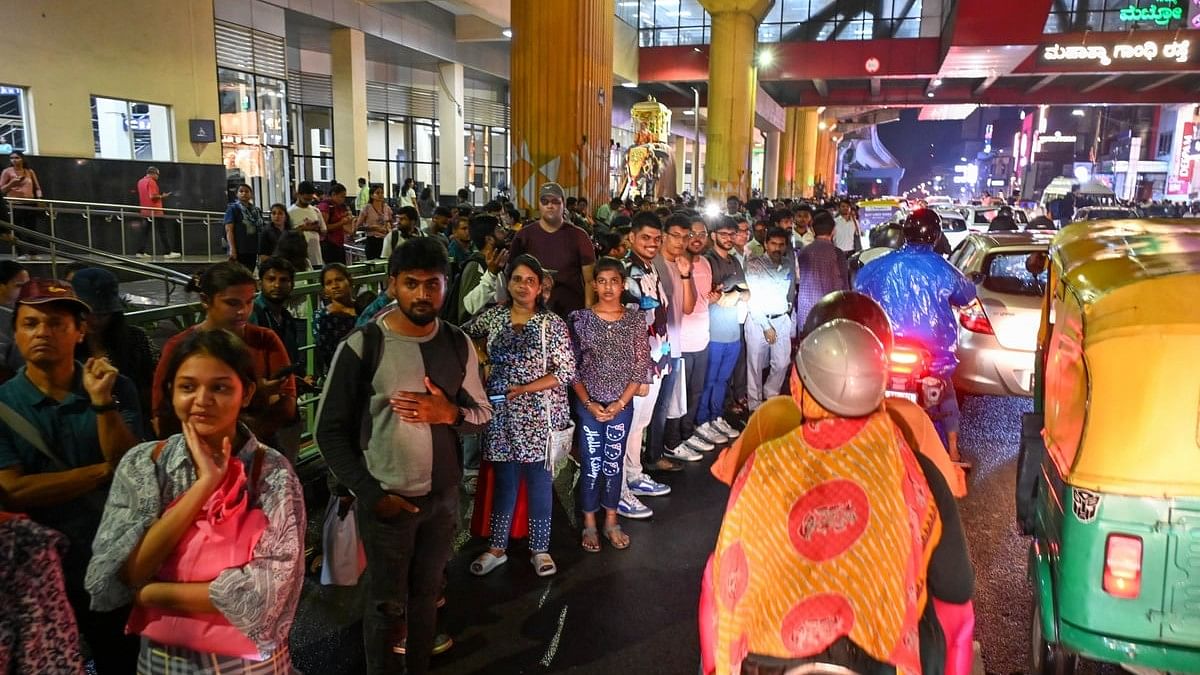 <div class="paragraphs"><p>Commuters struggle to find transport as metro services between MG Road and Indiranagar were suspended after an uprooted tree fell on the tracks before the Trinity station, in Bengaluru on Sunday evening. </p></div>