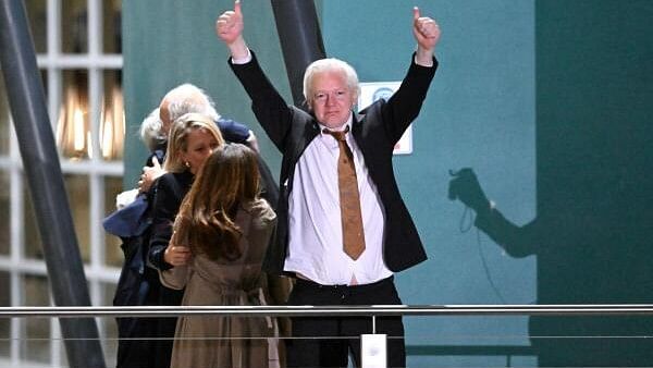 <div class="paragraphs"><p>WikiLeaks founder Julian Assange gestures at supporters after arriving at Canberra Airport, Canberra, Australia June 26, 2024.</p></div>