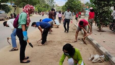 <div class="paragraphs"><p>Residents clear the dust-filled Balagere Road </p></div>