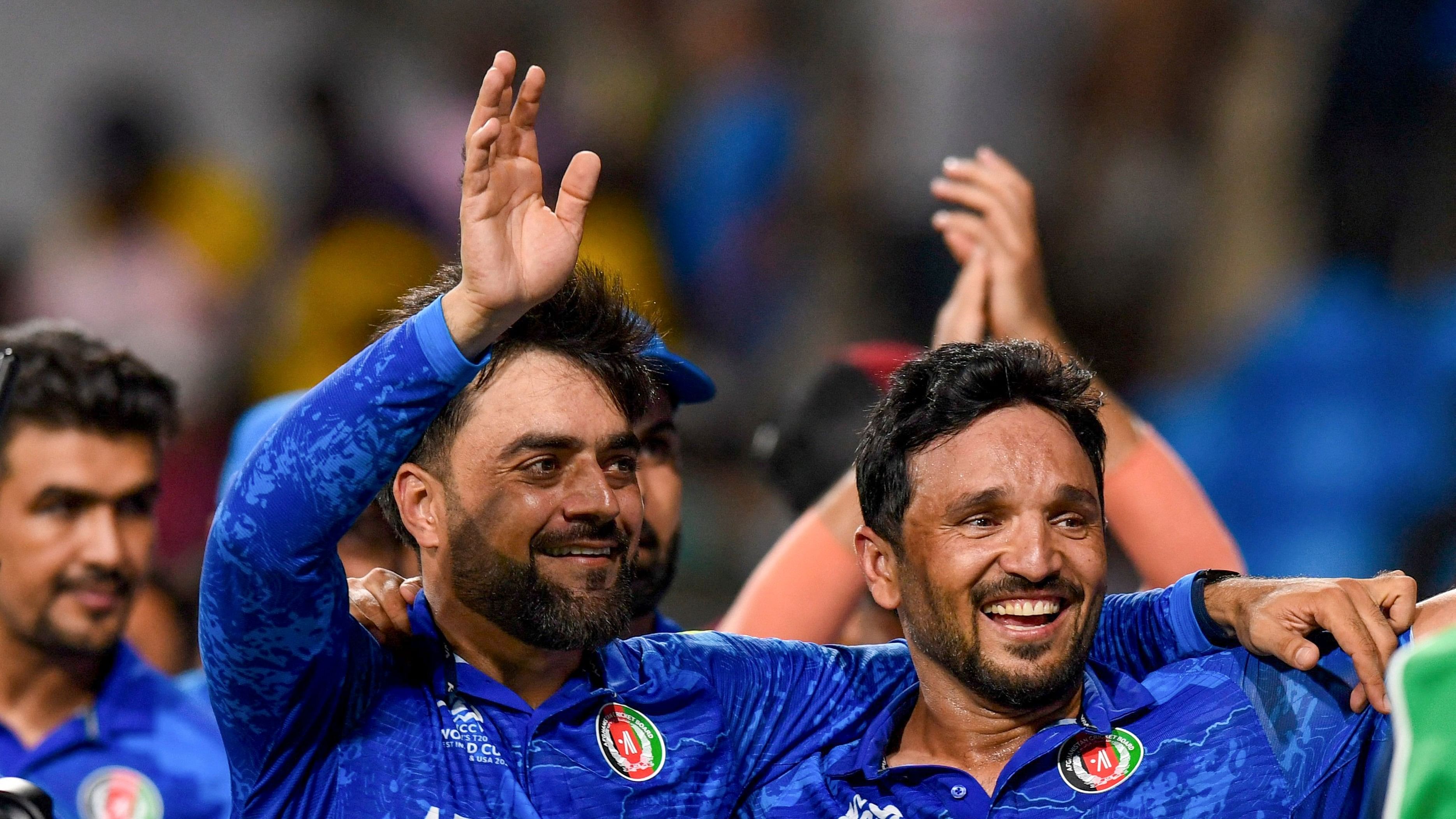 <div class="paragraphs"><p>Afghanistan's captain Rashid Khan with teammate Gulbadin Naib acknowledges fans after Afghanistan won the ICC Men's T20 World Cup cricket match against Bangladesh, at Arnos Vale Ground, Kingstown, Saint Vincent and the Grenadines, Monday, June 24, 2024.</p></div>