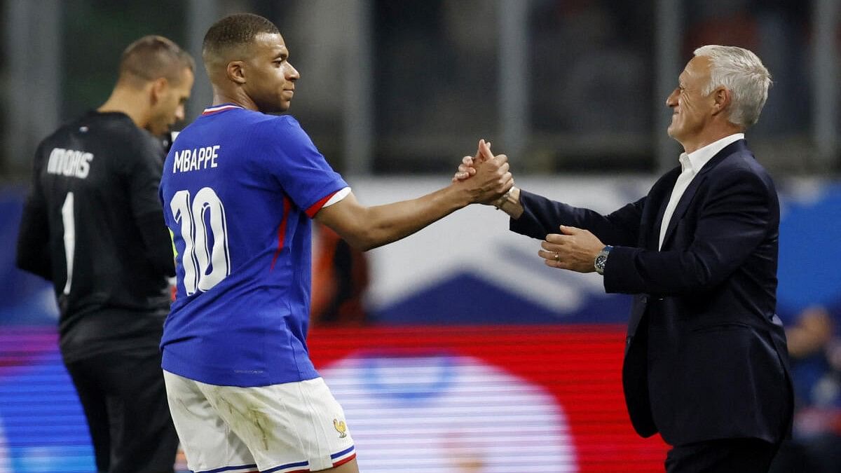 <div class="paragraphs"><p>France's Kylian Mbappe shakes hands with coach Didier Deschamps</p></div>