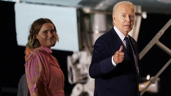 <div class="paragraphs"><p>US President Joe Biden gestures as he boards Air Force One with his granddaughter Maisy, at Brindisi Airport, on the second day of the G7 summit in Puglia, in Brindisi, Italy.</p></div>