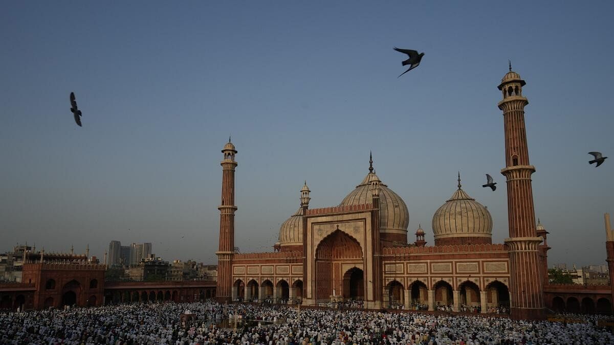 <div class="paragraphs"><p>Muslim devotees offer 'namaz' on Eid al-Adha festival, at Jama Masjid in New Delhi.</p></div>