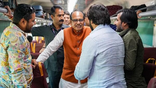 <div class="paragraphs"><p>Union Agriculture and Rural Development minister Shivraj Singh Chouhan interacts with passengers as he travels in the 'Shatabdi Express' train from New Delhi. </p></div>