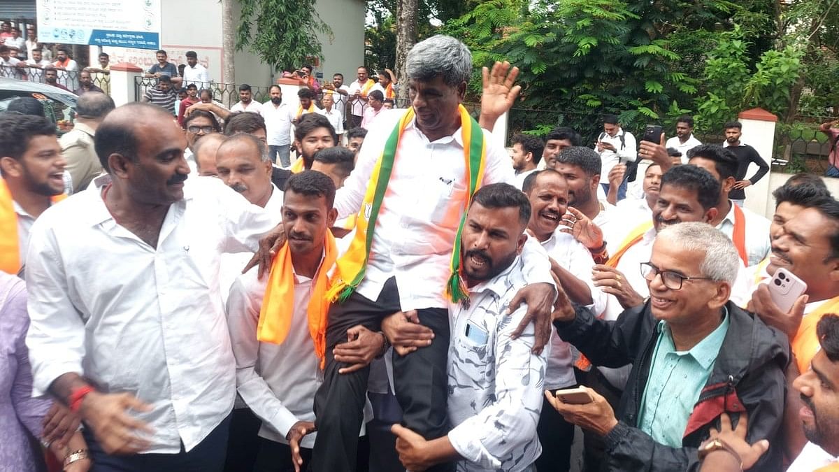 BJP workers celebrate with winning party candidate from Udupi Chickmagalur Kota Srinivas Poojary after the counting of votes in Udupi on Tuesday.