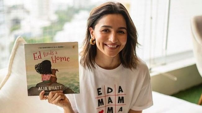 <div class="paragraphs"><p>Alia Bhatt holding her book&nbsp;<em>"The Adventures of Ed-a-Mamma: Ed Finds A Home",</em>&nbsp;which she&nbsp;dedicated to her 19-month-old daughter Raha.</p></div>