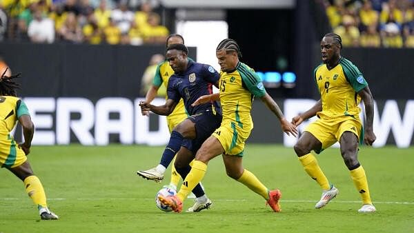 <div class="paragraphs"><p> Jamaica defender Joel Latibeaudiere and Ecuador midfielder John Yeboah battle for the ball</p></div>