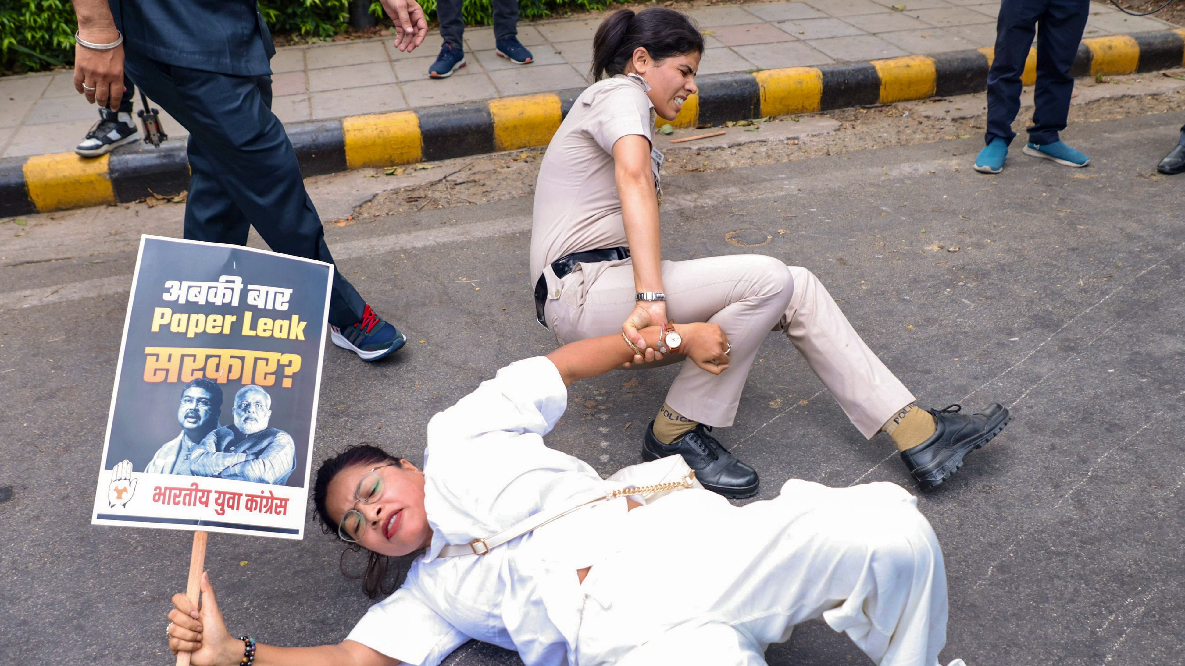 <div class="paragraphs"><p>A policewoman detains a member of IYC during a protest over the NEET-UG and UGC-NET examinations issue, in New Delhi, Thursday, June 20, 2024.</p></div>