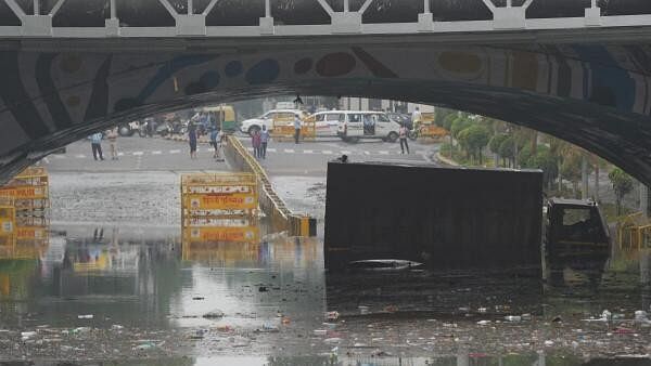 <div class="paragraphs"><p>A lorry is stuck in clogged water under Minto rail Bridge after a heavy rain in New Delhi, India, Friday, June 28, 2024.</p></div>