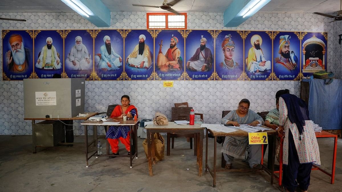 <div class="paragraphs"><p>A woman waits to get her voting slip before casting her vote at a polling station during the seventh and last phase of the general election Punjab.</p></div>