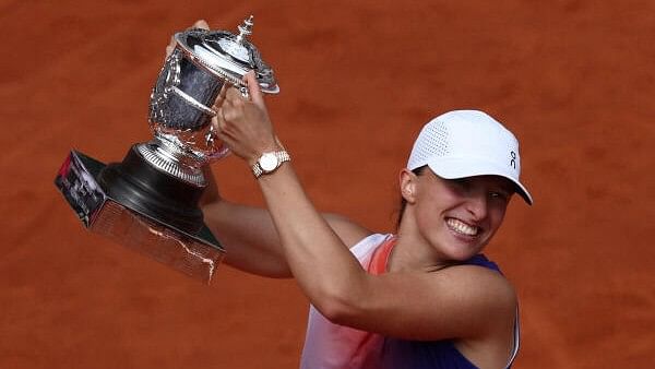 <div class="paragraphs"><p>Poland's Iga Swiatek celebrates with the trophy after winning her final match against Italy's Jasmine Paolini</p></div>