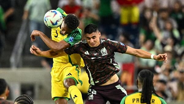 <div class="paragraphs"><p>Jamaica defender Ethan Pinnock and Mexico forward Guillermo Martinez  goes up for a header during the second half at NRG Stadium. </p></div>