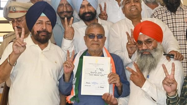 <div class="paragraphs"><p>Congress candidate from Patiala constituency Dharamvira Gandhi receives certificate at a counting center after winning the Lok Sabha elections, in Patiala, Tuesday, June 4, 2024.</p></div>