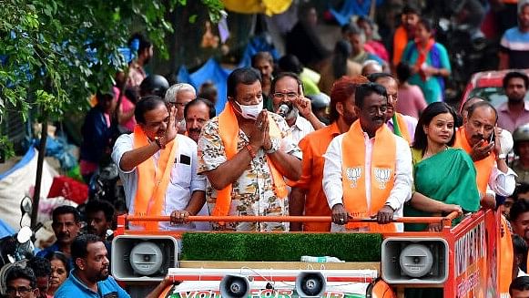 <div class="paragraphs"><p>BJP's Suresh Gopi(in mask), who won the sole seat for BJP in Kerala in Thrissur.</p></div>