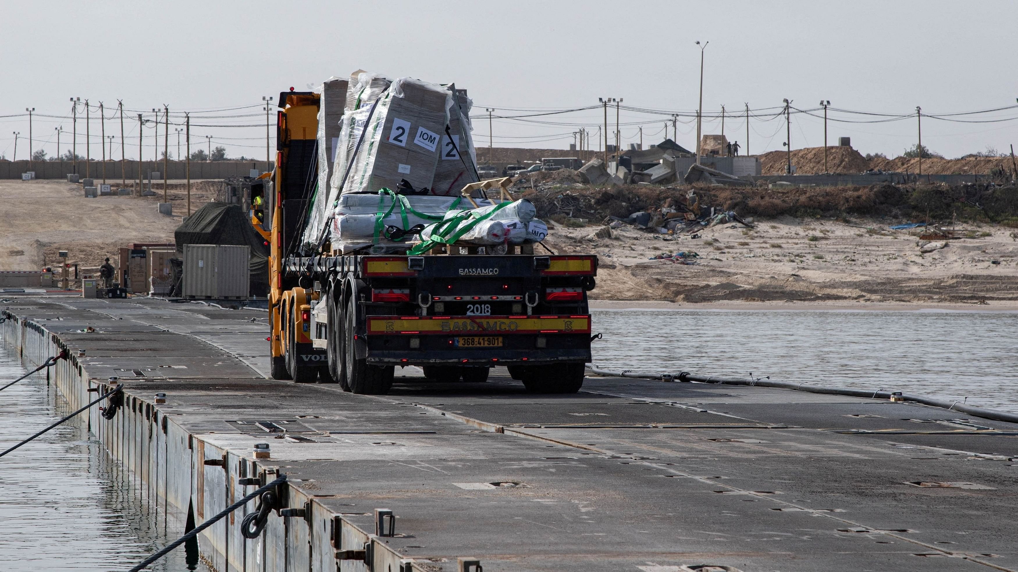 <div class="paragraphs"><p>A truck carries humanitarian aid across Trident Pier, a temporary pier to deliver aid, off the Gaza Strip, amid the ongoing conflict between Israel and the Palestinian Islamist group Hamas, near the Gaza coast.</p></div>