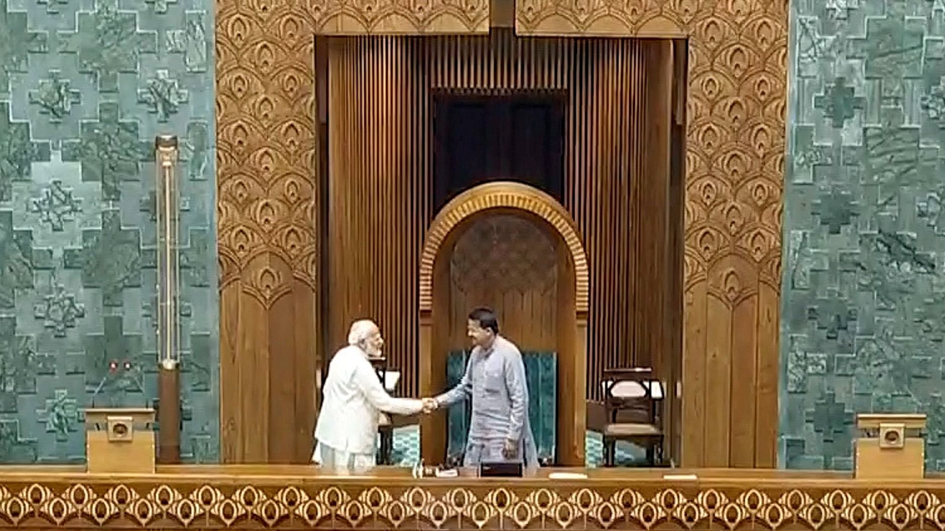 <div class="paragraphs"><p>Prime Minister Narendra Modi shakes hands with Speaker pro-tem B Mahtab after taking oath as a member of the House.</p></div>