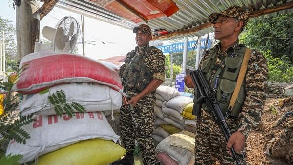 <div class="paragraphs"><p>Security personnel stand guard outside a counting centre, a day before counting of votes for the Lok Sabha elections, in Jammu, Monday, June 3, 2024.</p></div>