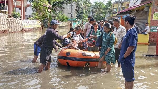 <div class="paragraphs"><p>State Disaster Response Force (SDRF) personnel rescue people from a flooded area, following incessant rains, in Guwahati.&nbsp;</p></div>