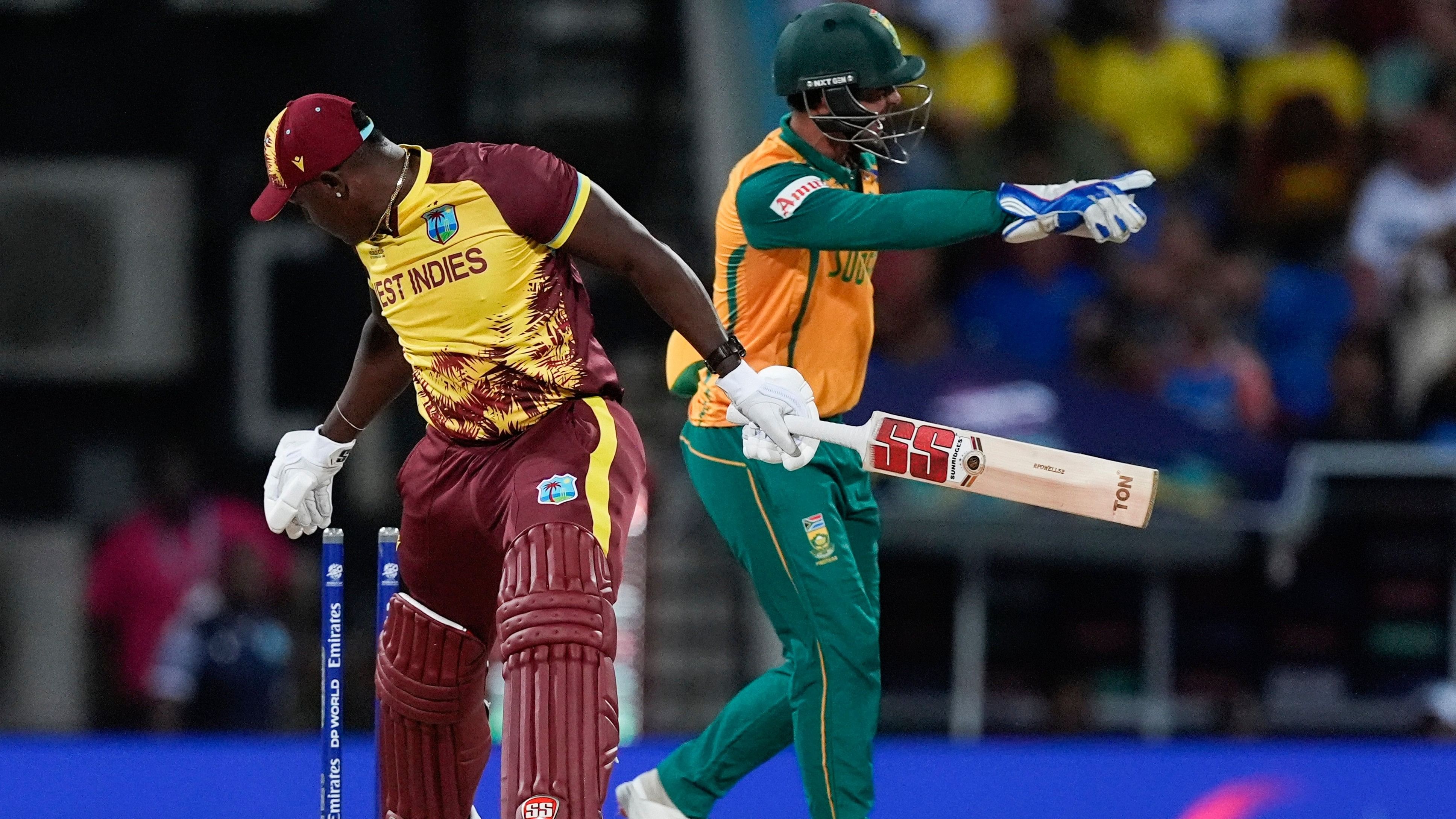 <div class="paragraphs"><p>West Indies' Rovman Powell, left, reacts after he was stumped by South Africa's Quinton de Kock during the ICC Men's T20 World Cup cricket match between the West Indies and South Africa.</p></div>