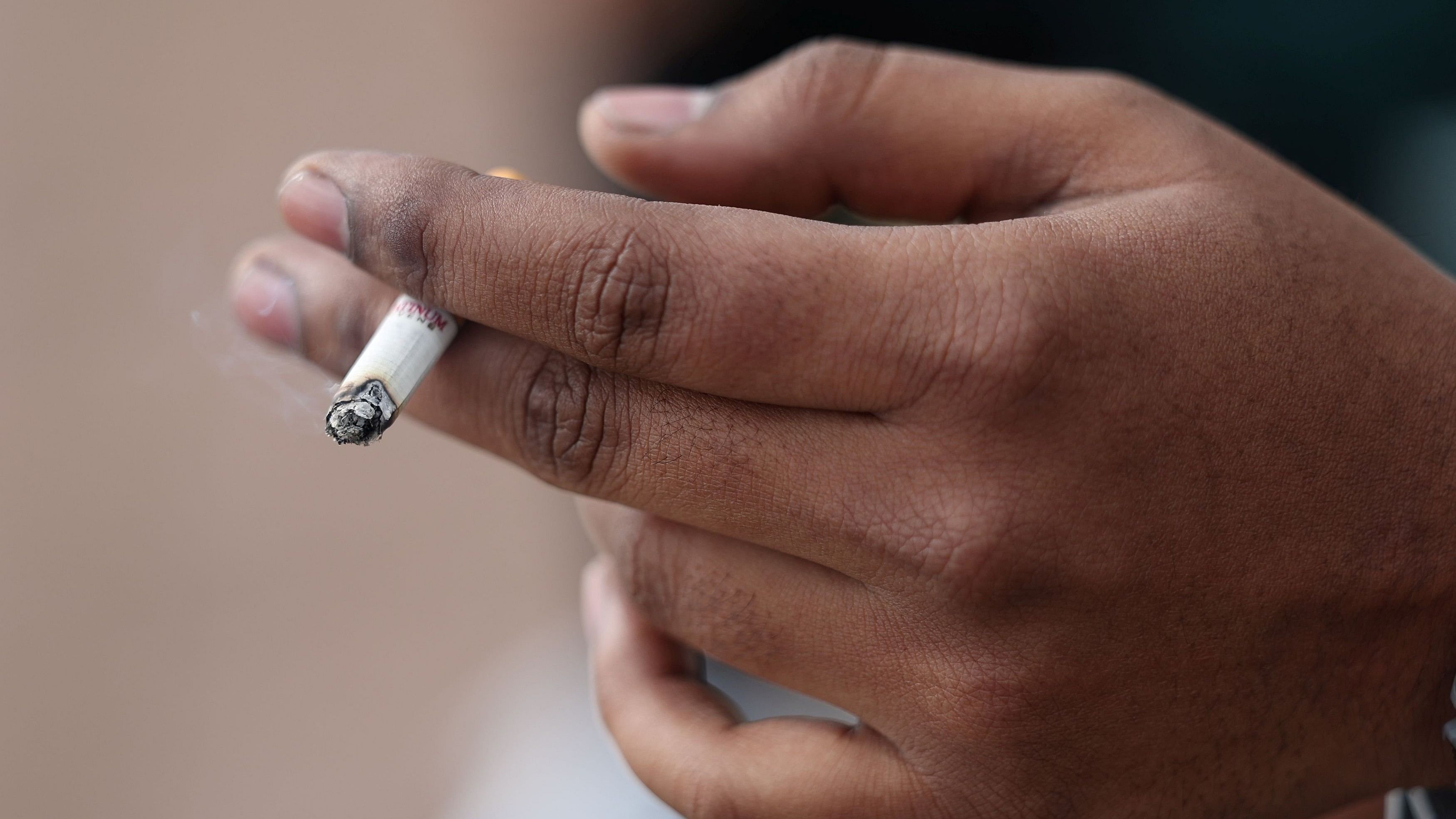 <div class="paragraphs"><p>A man holds his cigarette as he smokes. (Representative Image)</p></div>