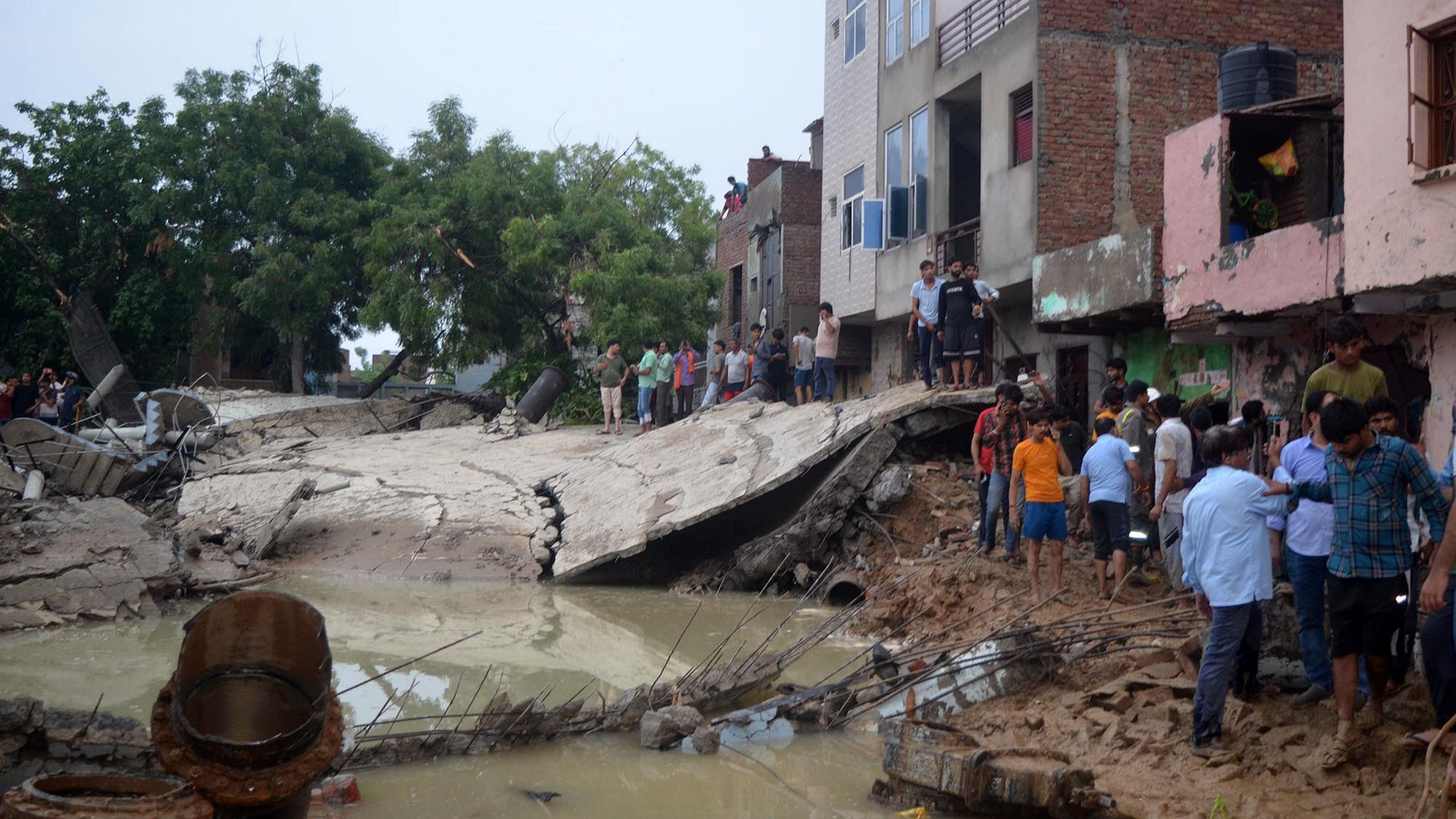 <div class="paragraphs"><p>Mathura: People near the debris after a water tank collapsed due to heavy rainfall, in Mathura, Sunday, June 30, 2024.</p></div>