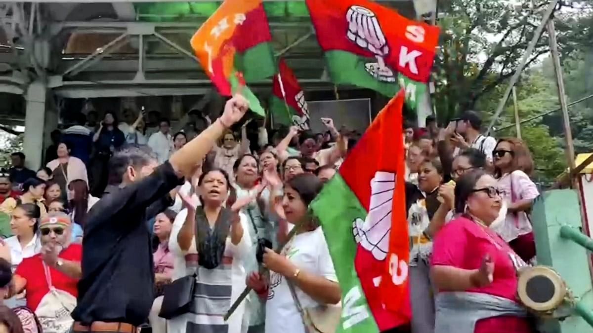 <div class="paragraphs"><p>Sikkim Krantikari Morcha (SKM) members wave the party flag.</p></div>