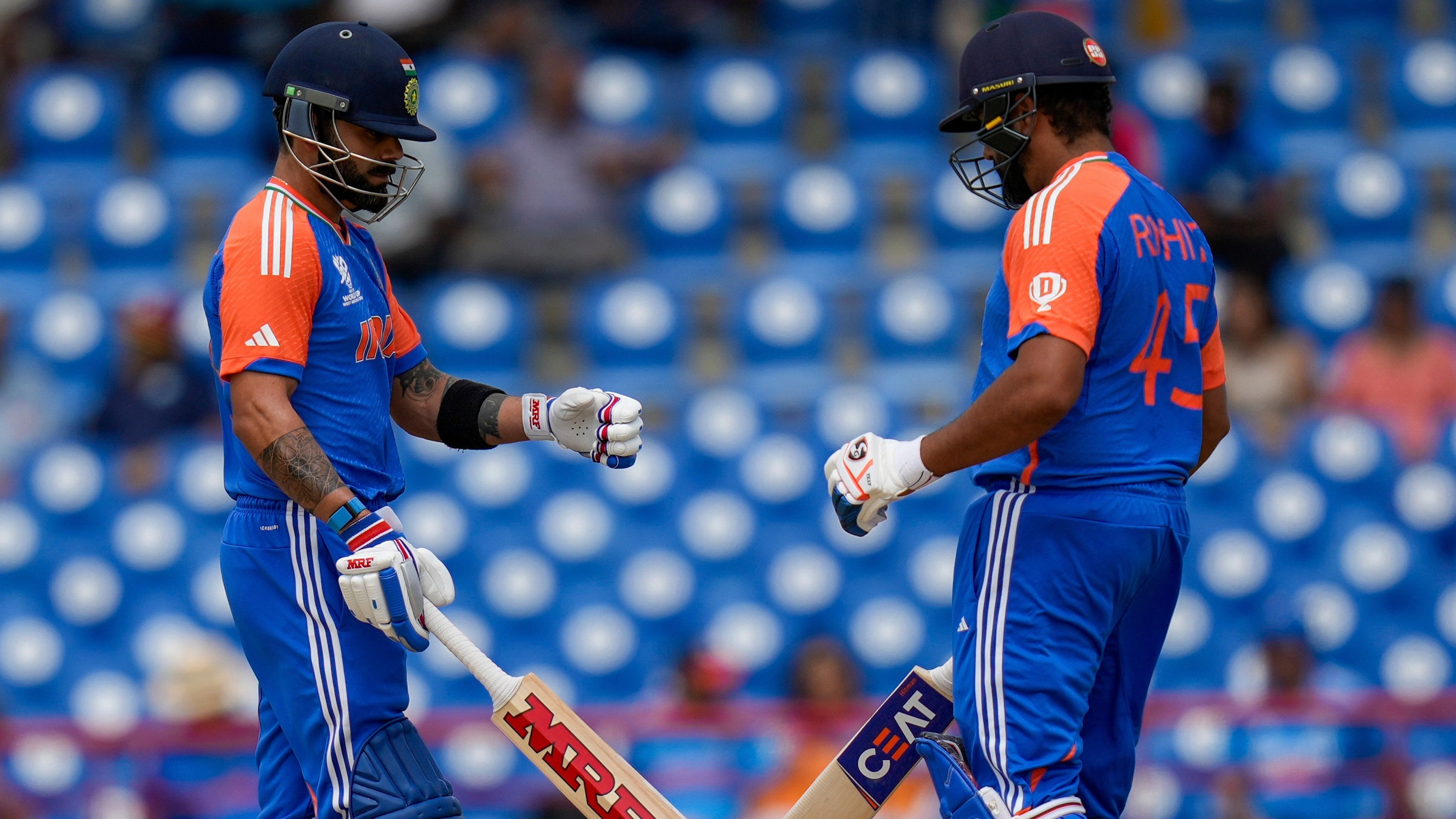 <div class="paragraphs"><p>Virat Kohli, left, knock bats with captain Rohit Sharma during an ICC Men's T20 World Cup cricket match against Australia at Darren Sammy National Cricket Stadium in Gros Islet, Saint Lucia, Monday, June 24, 2024.</p></div>