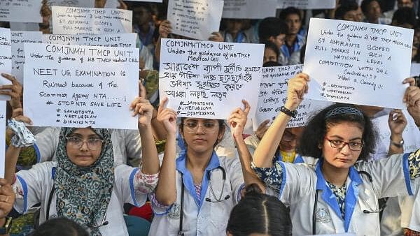 <div class="paragraphs"><p>Medical students and junior doctors under banner of Trinamool Congress Medical Cell participate in a protest against alleged irregularities in NEET-UG 2024 Entrance Examination results, in Kolkata, Tuesday, June. 11, 2024</p></div>