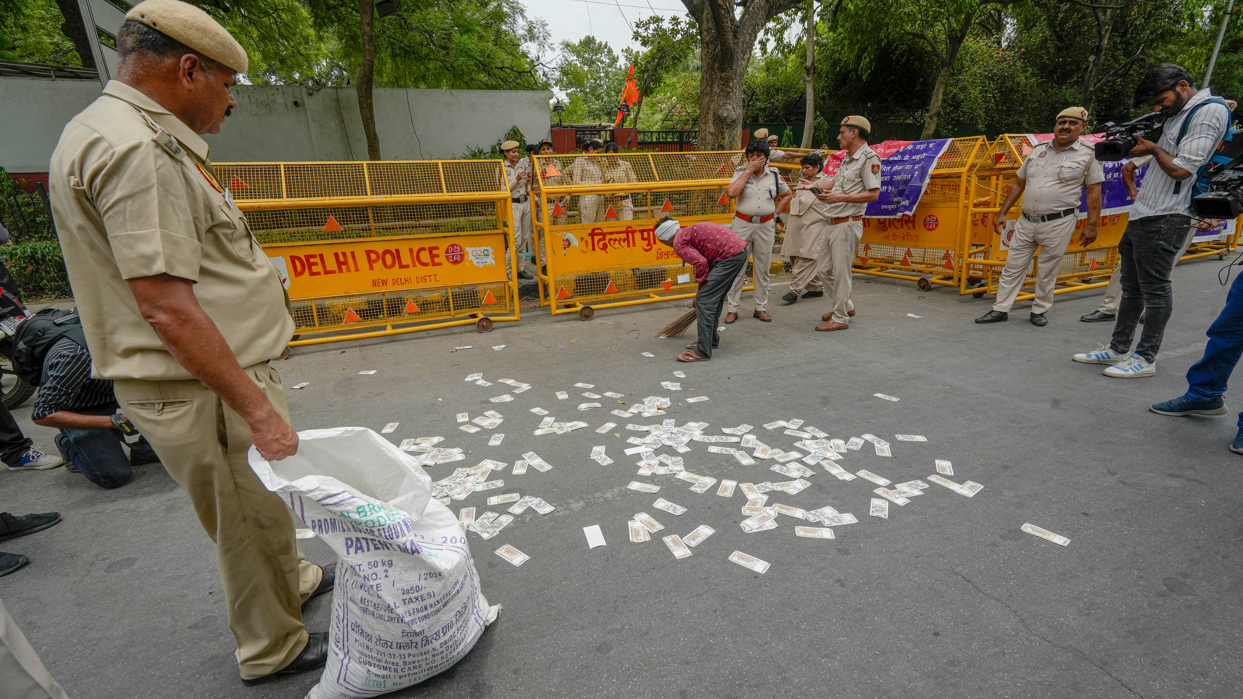 <div class="paragraphs"><p>Fake currency notes used by members of NSUI during their protest  over the NEET-UG and UGC-NET examinations issue being removed from the road, in New Delhi, Thursday, June 20, 2024.</p></div>