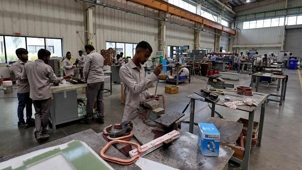 <div class="paragraphs"><p>Employees assemble an electric transformer inside a manufacturing unit of Inductotherm (India) Private Limited at Sanand GIDC (Gujarat Industrial Development Corporation), on the outskirts of Ahmedabad.&nbsp;</p></div>