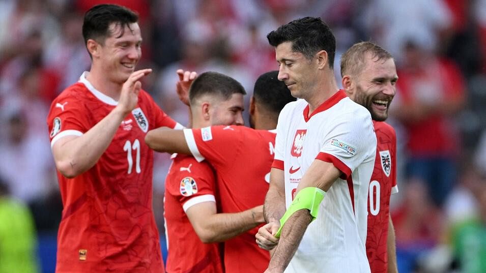 <div class="paragraphs"><p>Austria's Romano Schmid, Michael Gregoritsch, Konrad Laimer and Phillipp Mwene celebrate as Poland's Robert Lewandowski looks dejected after the match.</p></div>